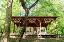 A Motorhome Underneat A Wooden Canopy With Vintage American Flags Along The Cape Fear River, North Carolina