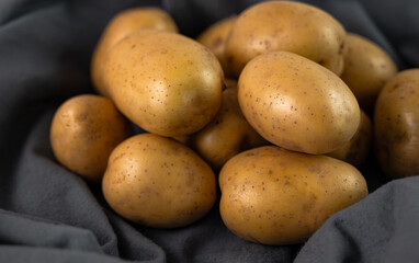 Potato close-up on gray fabric