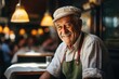 © Distinctive Images - Cheerful Elderly Chef Smiling in a Cozy Restaurant Setting
