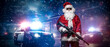 © Fxquadro - A man dressed as Santa Claus, holding a machine gun, poses in front of police cars with numerous police lights and sirens, amid a snowy stormy night on the street
