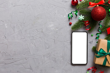 Wall Mural - Digital phone mock up with rustic Christmas decorations for app presentation top view with empty space for you design. Christmas online shopping concept. Tablet with copy space on colored background