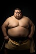 japanese sumo wrestler posing sitting in front of the camera in the studio