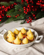 © Arantxa Forcada - Top view of plate with molds with mashed potatoes, on white tablecloth with Christmas decoration, vertical