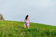 © dmitriisimakov - brunette woman running across field in nature travel walk