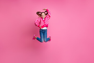 Full length photo of glamour positive girl dressed trendy jeans outfit showing object product empty space isolated on pink color background