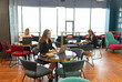 © SlavaStock - Ladies employees wearing office outfits occupy different desks. Colleagues actively work on tasks for collaborative project in secure office