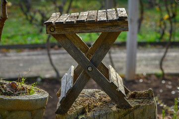 Wall Mural - First shot of a small folding garden table, dry, old, among other utensils, tools and gardening pots, in a view of autumn, old, cold and decadent waiting for new life of old glory.