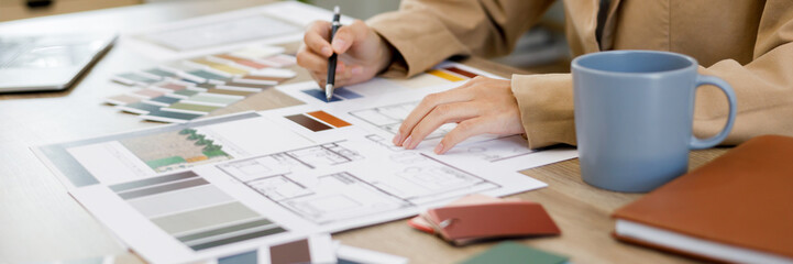 Fototapete - Architects interior designer hands working with Blue prints and documents for a home renovation for house design.