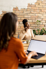 Wall Mural - Two young business women working  in the modern office