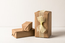 Holiday Gifts Wrapped In Kraft Paper On White Background