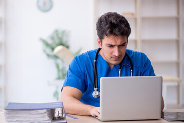 Wall Mural - Young male doctor in telemedicine concept