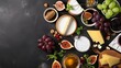 Assorted cheese plate or charcuterie board with sliced varieties of cheese, figs, honey, sauce, and grapes. A delectable display of textures and flavors, perfect for a gourmet experience.