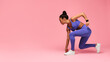 Motivated Black Lady Runner Doing Crouch Start On Pink Background