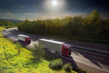 Wall Mural - Large Transportation Truck on a highway road through the countryside at sunset