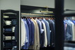 loja de roupas masculinas em cores neutras, tons de azuis. camisas, casacos e calcas dobradas em ambiente clássico e organizado.