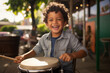 child playing drum, portrait of a happy young hispanic boy smiling thrilled, curly hair, outdoors in town, wearing a jacket, intense expression, playful smile, joy, latino