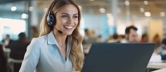 Beautiful happy smiling customer service woman working on computer in office