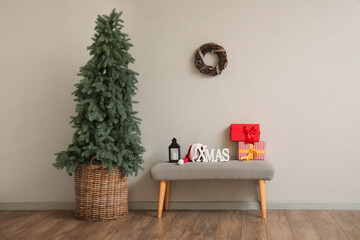 Interior of living room with soft bench and Christmas tree