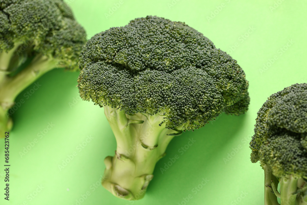 Fresh broccoli cabbages on green background