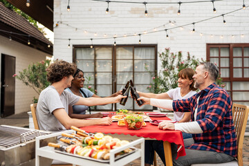 Multi-ethnic family having fun, enjoy party outdoors in the garden.