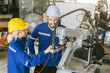© Quality Stock Arts - Engineer team worker fix service replace broken part of automatic industry robotic welding arm. Happy staff repair maintenance robot welding machine.