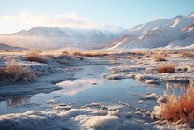Tranquil Winter River Scene: Early Morning Light On A Frozen Stream Amidst Snowy Hills