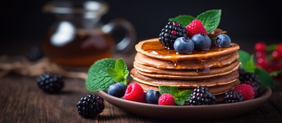 Canvas Print - Selective focus on buckwheat pancakes with berries and honey.