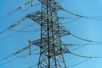 High voltage towers with sky background. Power line support with wires for electricity transmission. High voltage grid tower with wire cable at distribution station. Energy industry, energy saving