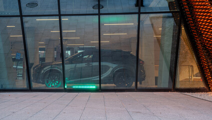 Wall Mural - Modern glass and metal building with visible car inside