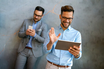 Wall Mural - Diverse business people colleagues laughing having fun with digital gadgets in office.