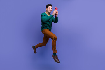 Photo of glad cheerful man wear stylish clothes read instagram telegram social media news isolated on violet color background