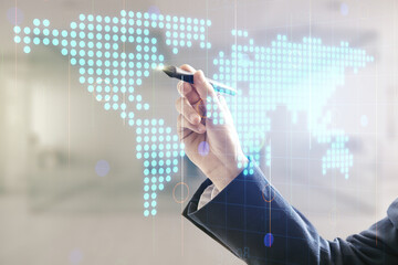 Poster - Man hand with pen working with abstract creative digital world map on blurred office background, globalization concept. Multiexposure