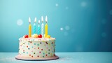 Fototapeta Tęcza - Celebration birthday cake with colorful sprinkles and colorful birthday candles