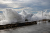 Fototapeta  - Rough sea with big waves on the piers of the Genoa seafront, Italy