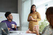 © DragonImages - Indian business colleagues in traditional clothes having coffee and discussing news and gossips