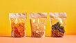 Transparent zip bags with dried fruits and nuts on an orange background.