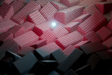3D Render Of Sphere Glowing Over Heap Of Pink Cloth Tiles