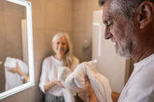 Man Holding Towel In Bathroom At Home