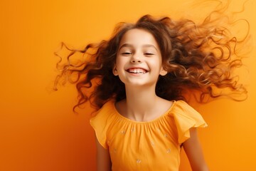 Poster - Cute Young Happy Girl iDancing on a Orange Background with Space for Copy