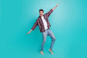 Canvas Print - Full length photo of dreamy carefree guy wear checkered shirt dancing having fun isolated teal color background