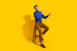 © deagreez - Full size photo of pleasant guy dressed striped shirt indicating at profitable proposition empty space isolated on yellow color background