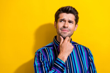 Sticker - Photo of suspicious gloomy man dressed striped shirt hold finger on chin look empty space isolated on vivid yellow color background