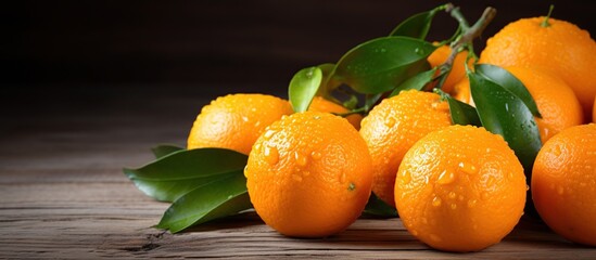 Wall Mural - Fresh orange tangerine fruit with leaves on a wooden background