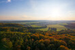 Serene autumnal panorama, european village, fields, and forest from a drone's eye view