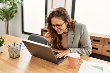 Canvas Print - Young beautiful hispanic woman business worker having video call at office