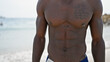 African american man tourist standing shirtless at the beach
