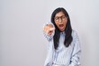 © Krakenimages.com - Young hispanic woman wearing glasses pointing displeased and frustrated to the camera, angry and furious with you