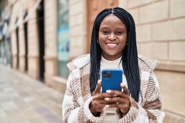 Sticker - African american woman smiling confident using smartphone at street