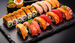 Assorted sushi nigiri and maki set on slate.