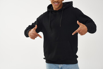 trendy african american male model in casual black hoodie and jeans, copy space for advertising